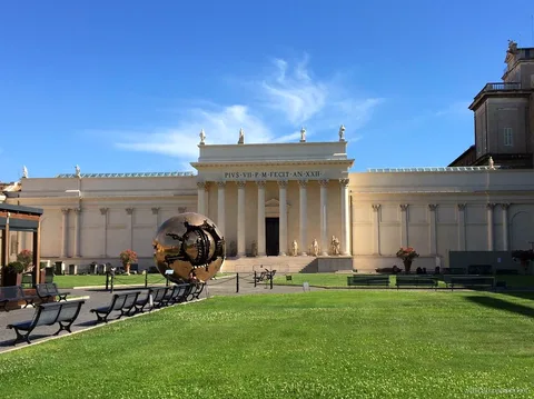 Sphere Within Sphere bronze sculpture in the Cortile della Pigna, seen with a Vatican pass ticket