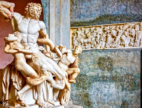 Laocoön marble sculpture group beside a carved relief frieze, a Vatican pass ticket highlight in the Vatican Museums