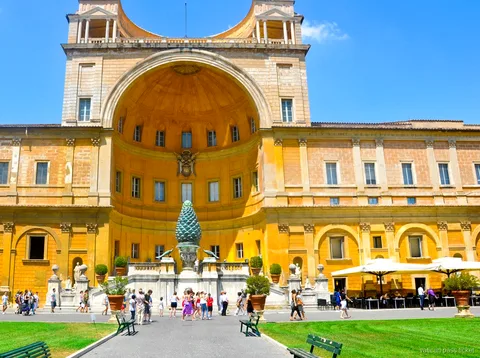 Bronze pine cone and giant niche of the Cortile della Pigna with visitors, reached on a Vatican pass ticket